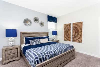 a bedroom with a bed and two night stands at Blue Moon House in Kissimmee