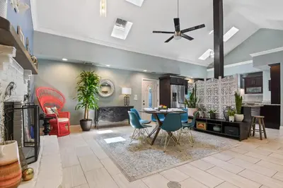 a living room with a table and chairs at Best Location Pet Friendly Fenced Yard in Orlando