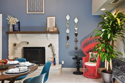 a living room with a table and a fireplace at Best Location Pet Friendly Fenced Yard in Orlando