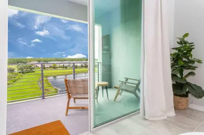 a room with a view of a balcony at Gorgeous 2Bd Apto Close to Disney @ Storey Lake 404 3191 in Kissimmee