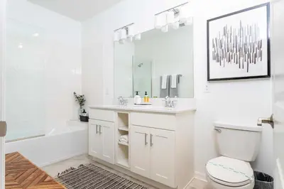 a white bathroom with a sink and a toilet at Gorgeous 2Bd Apto Close to Disney @ Storey Lake 404 3191 in Kissimmee