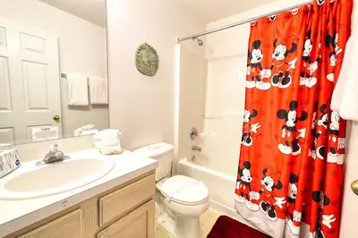 a bathroom with a sink and a toilet and a shower curtain at Clear Creek 3 Bedroom Home Private Pool 15 Min to Disney in Orlando