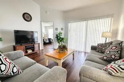 a living room with two couches and a coffee table at Clear Creek 3 Bedroom Home Private Pool 15 Min to Disney in Orlando