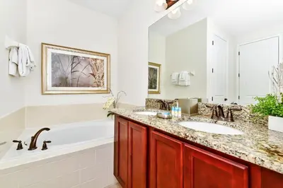 a bathroom with two sinks and a bath tub and a tub at Spectacular Home Near Disney With Private Pool And Waterpark & Resort Access At Encore Resorts Reunion - 7523Mr in Kissimmee