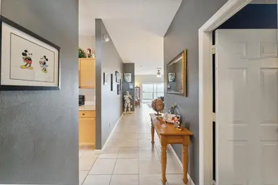a hallway with a table and a kitchen at Vacation Resort Home Right Outside of Disney World Parks with Private Pool home in Kissimmee