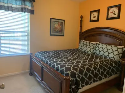 a bedroom with a bed and a window at Windsor Hill Resort Home w Pool, 5 Min from Disney in Orlando