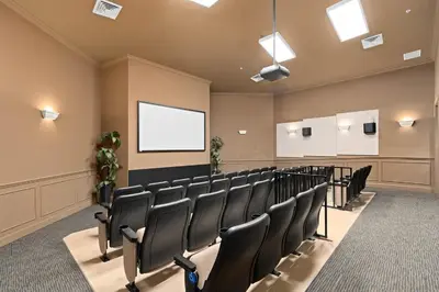 a conference room with chairs and a white screen at Windsor Hill Resort Home w Pool, 5 Min from Disney in Orlando
