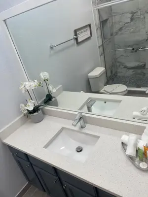 a bathroom with a sink and a large mirror at Home sweet Home near Disneyland in Kissimmee
