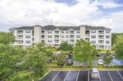 an aerial view of a large apartment building with a parking lot at Home sweet Home near Disneyland in Kissimmee