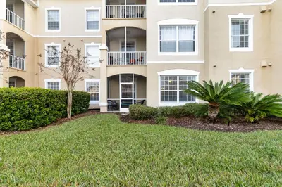 a large apartment building with a lawn in front of it at Making Memories At Windsor Palms Resort, Great Amenities And Much More Fun! in Kissimmee