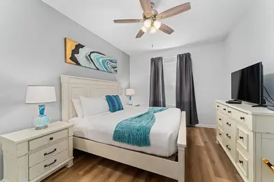 a bedroom with a bed and a ceiling fan at Vista Cay Resort in Orlando