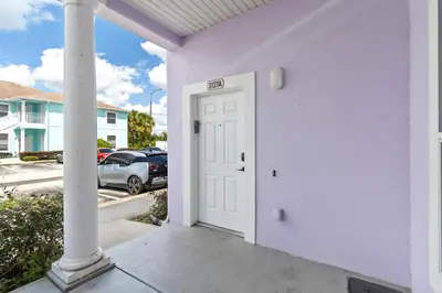 a purple house with a white door in a parking lot at Huge Screened Patio That Overlooks Lake Buck, Near Famous Attractions!! in Orlando