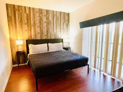 a bedroom with a bed and a large window at Huge Screened Patio That Overlooks Lake Buck, Near Famous Attractions!! in Orlando