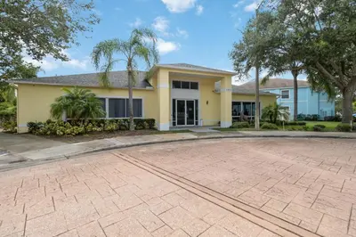 a house with a driveway in front of it at Huge Screened Patio That Overlooks Lake Buck, Near Famous Attractions!! in Orlando