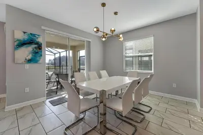a dining room with a white table and chairs at Storey Lake Resort, Private Pool, And Much More!! in Kissimmee