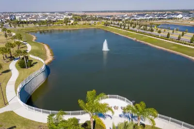a sailboat in the middle of a lake with palm trees at 1798 TP - 4BR Luxury Solara Retreat Pool Disney in Orlando