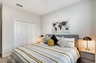 a white bedroom with a large bed with pillows at 2773 BD - 5Bd Home with Private Pool 14 Guests in Kissimmee