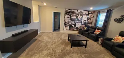 a living room with a couch and a tv at 2859 BD - Grand Luxury Villa with a Sparkling Pool in Kissimmee