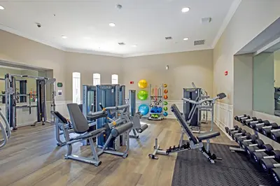 a gym with treadmills and machines in a room at Epic Universe Vista Cay Lakeview Condo - 1019 in Orlando