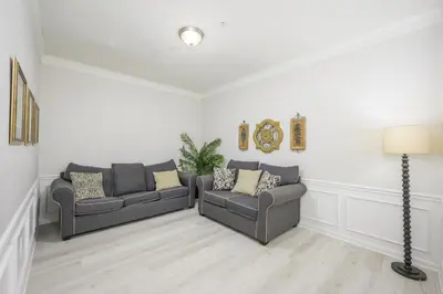 a living room with two couches and a lamp at Epic Universe Vista Cay Lakeview Condo - 1019 in Orlando