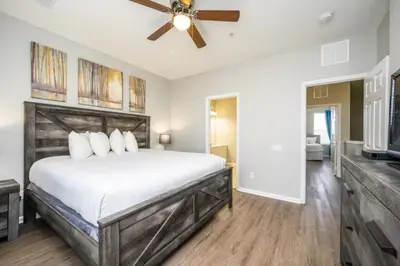 a bedroom with a bed and a ceiling fan at Epic Universe New Listing Beautiful Townhome, Vista Cay 4019 in Orlando