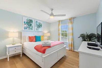 a bedroom with a bed and a desk with a computer at Peach Odyssey At Storey Lake By Shine Villas #908 in Kissimmee