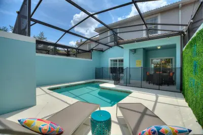 a swimming pool in the backyard of a house at Peach Odyssey At Storey Lake By Shine Villas #908 in Kissimmee