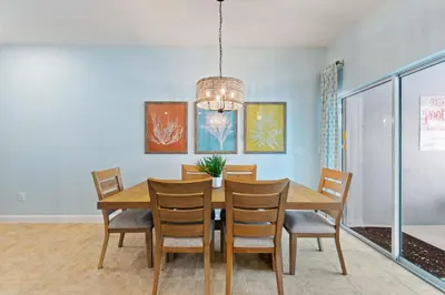 a dining room with a table and chairs at Peach Odyssey At Storey Lake By Shine Villas #908 in Kissimmee