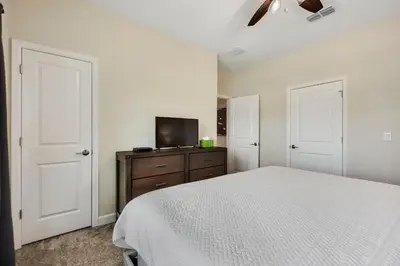 a bedroom with a bed and a flat screen tv at Barefoot Breeze - Storey Lake By Shine Villas #833 in Kissimmee