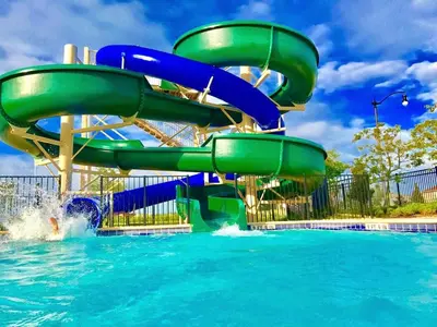 a water slide in a pool at a water park at Barefoot Breeze - Storey Lake By Shine Villas #833 in Kissimmee