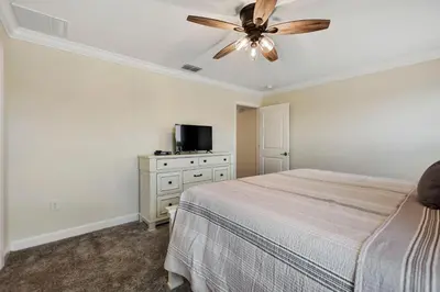 a bedroom with a bed and a ceiling fan at Barefoot Breeze - Storey Lake By Shine Villas #833 in Kissimmee