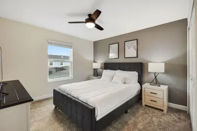 a bedroom with a bed and a ceiling fan at Magic Lily - Storey Lake By Shine Villas #834 in Kissimmee