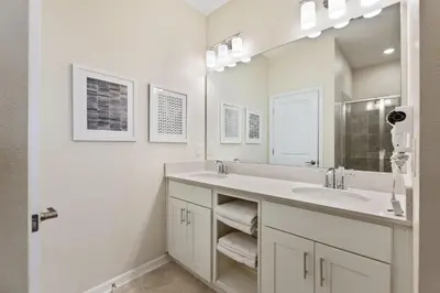 a white bathroom with a sink and a mirror at Blue Toucan At Storey Lake By Shine Villas #402 in Kissimmee