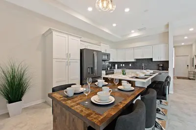 a kitchen and dining room with a table and chairs at Blue Toucan At Storey Lake By Shine Villas #402 in Kissimmee