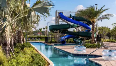 a water slide in a pool at a resort at Happy Haven At Storey Lake Resort By Shine Villas #409 in Kissimmee