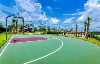 a basketball court at a park with palm trees at Blue Beach At Storey Lake By Shine Villas #400 in Kissimmee