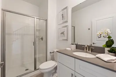 a bathroom with a toilet and a shower and a sink at Blue Beach At Storey Lake By Shine Villas #400 in Kissimmee