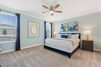 a bedroom with a bed and a ceiling fan at Stars Align Storey Lake By Shine Villas #406 in Kissimmee
