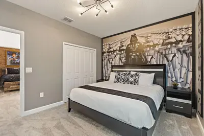 a bedroom with a bed with a painting on the wall at Stars Align Storey Lake By Shine Villas #406 in Kissimmee