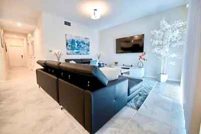 a living room with a couch and a tv at Vacation Meadows - Storey Lake By Shine Villas #710 in Kissimmee