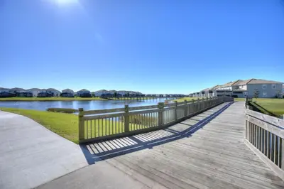 a wooden boardwalk next to a body of water at Lake View At Storey Lake By Shine Villas #703 in Kissimmee