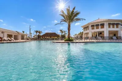 a large swimming pool in front of a building at Lake View At Storey Lake By Shine Villas #703 in Kissimmee