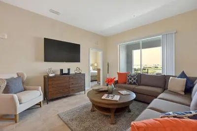 a living room with a couch and a table at Firecracker View Storey Lake By Shine Villas #838 in Kissimmee