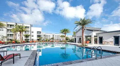 a swimming pool with palm trees and buildings at Firecracker View Storey Lake By Shine Villas #838 in Kissimmee