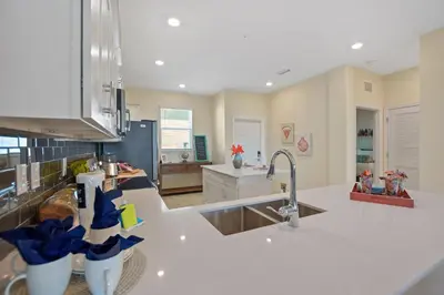 a kitchen with white counter tops and a sink at Firecracker View Storey Lake By Shine Villas #838 in Kissimmee