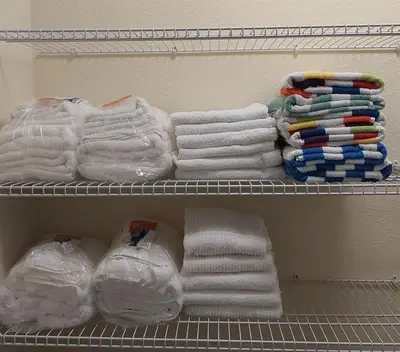 a shelf with towels and other towels in a closet at 350 Pendant · 350 Villa - 8BD - Private Pool - Game room in Orlando