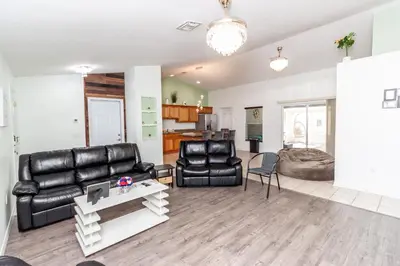 a living room with a couch and a table at Gorgeous Fully Furnished 2-Bedroom Luxury Villa in Kissimmee
