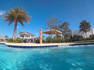 a swimming pool with blue water in front of a house at Serenity Haven, Bliss, Storey Lake By Shine Villas #701 in Kissimmee