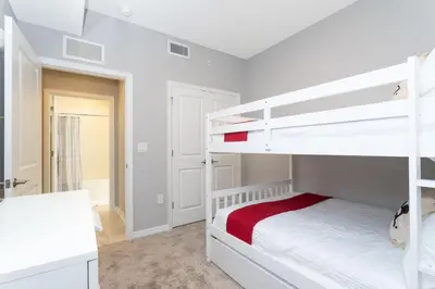 a bedroom with two bunk beds and a desk at Sweet Suite Sleeps 6 Storey Lake By Shine Villas #903 in Kissimmee