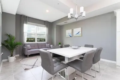 a dining room with a white table and chairs at Sweet Suite Sleeps 6 Storey Lake By Shine Villas #903 in Kissimmee